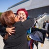 Graduate hugging guest
